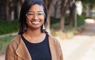 An image of Alyse Parker smiling in from of the Trellis headquarters.